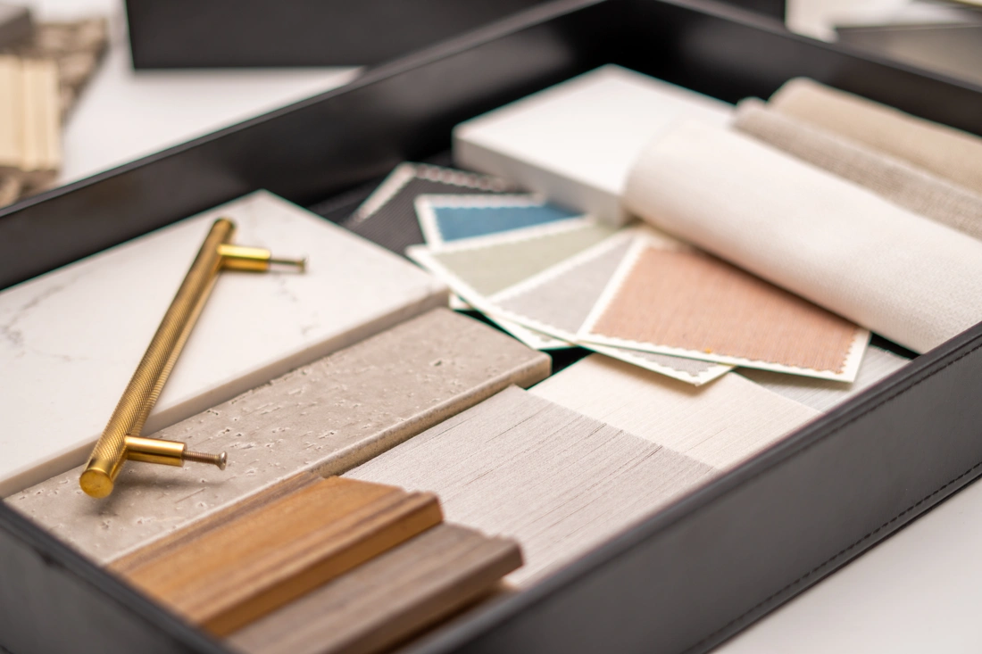 Curated wood, stone, fabric and brass samples for a custom home finish package, assembled by Forte Specialty Contractors